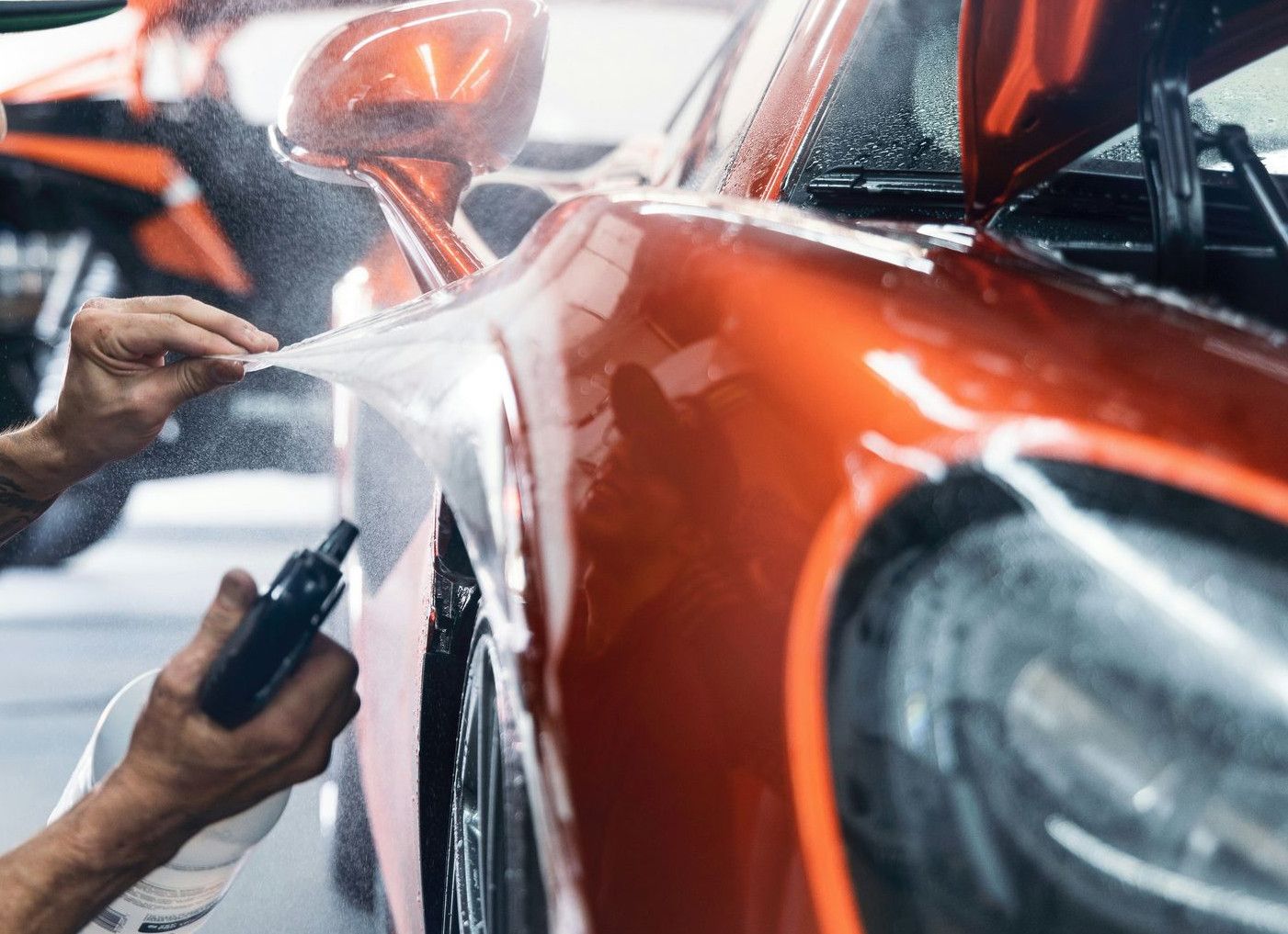 a man waxing a car in a garage